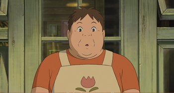 Movie still from “When Marnie Was There” (2014), directed by Hiromasa Yonebayashi – An animated picture of a man in an apron looking surprised; Close Up shot, Low angle