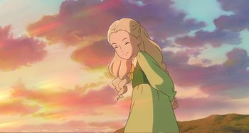Movie still from “When Marnie Was There” (2014), directed by Hiromasa Yonebayashi – A woman with long blonde hair standing in front of a sunset; Medium shot, Over the shoulder angle
