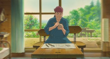 Movie still from “When Marnie Was There” (2014), directed by Hiromasa Yonebayashi – An animated man sitting at a table with a bowl of paint; Medium shot, High angle