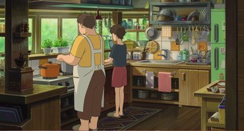 Movie still from “When Marnie Was There” (2014), directed by Hiromasa Yonebayashi – A couple of people standing in a kitchen preparing a meal; Wide shot, High angle