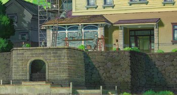 Movie still from “When Marnie Was There” (2014), directed by Hiromasa Yonebayashi – A painting of a house with a brick wall and scaffolding; Extreme Wide shot, Low angle