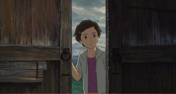 Movie still from “When Marnie Was There” (2014), directed by Hiromasa Yonebayashi – A woman standing in a doorway looking at the camera; Medium shot, High angle