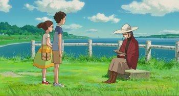 Movie still from “When Marnie Was There” (2014), directed by Hiromasa Yonebayashi – Two children and an old man are standing in front of a bench; Wide shot, Over the shoulder angle
