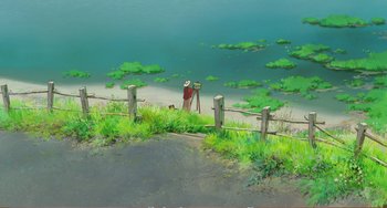 Movie still from “When Marnie Was There” (2014), directed by Hiromasa Yonebayashi – A person standing on the beach taking a picture of the water; Extreme Wide shot, High angle