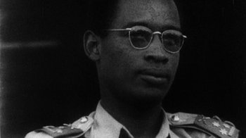 Movie still from “When We Were Kings” (1996), directed by Leon Gast – A black and white photo of a man wearing glasses; Close Up shot, Low angle