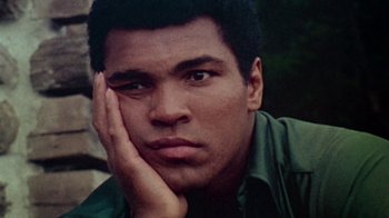 Movie still from “When We Were Kings” (1996), directed by Leon Gast – A person with his hand under his chin; Close Up shot, Low angle