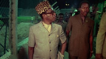 Movie still from “When We Were Kings” (1996), directed by Leon Gast – An older man wearing a leopard print hat; Medium shot, Low angle