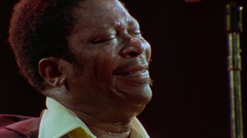 Movie still from “When We Were Kings” (1996), directed by Leon Gast – An older man is crying with his eyes closed; Extreme Close Up shot, Low angle