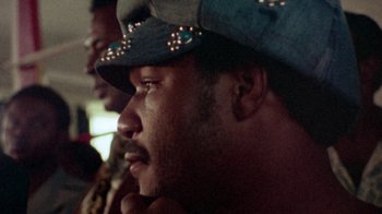 Movie still from “When We Were Kings” (1996), directed by Leon Gast – A person wearing a hat; Close Up shot, Low angle
