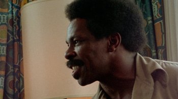 Movie still from “When We Were Kings” (1996), directed by Leon Gast – A person with a beard; Close Up shot, Low angle