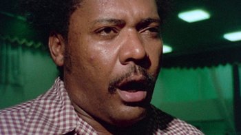 Movie still from “When We Were Kings” (1996), directed by Leon Gast – A person with a beard and mustache; Close Up shot, Low angle