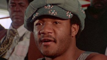 Movie still from “When We Were Kings” (1996), directed by Leon Gast – A person wearing a hat; Close Up shot, Low angle