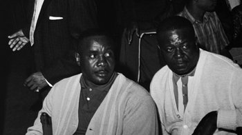 Movie still from “When We Were Kings” (1996), directed by Leon Gast – A black and white photo of two men sitting next to each other; Close Up shot, Low angle