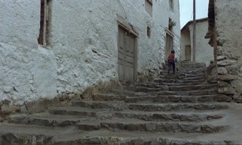 Movie still from “Where Is the Friend's House?” (1987), directed by Abbas Kiarostami – A person climbing up a set of stairs; Extreme Wide shot, High angle