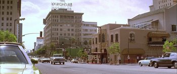 Movie still from “Where the Truth Lies” (2005), directed by Atom Egoyan – A street scene with a car driving down the road; Extreme Wide shot, High angle