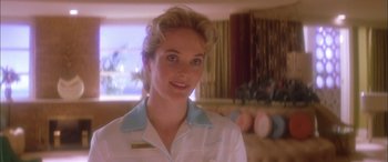 Movie still from “Where the Truth Lies” (2005), directed by Atom Egoyan – A woman wearing a white shirt and a blue collar; Close Up shot, Low angle