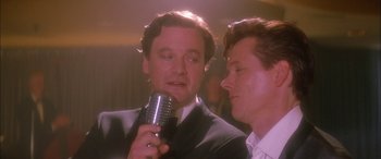 Movie still from “Where the Truth Lies” (2005), directed by Atom Egoyan – Two men in suits are talking into a microphone; Close Up shot, Low angle