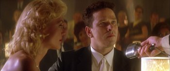 Movie still from “Where the Truth Lies” (2005), directed by Atom Egoyan – A man in a black suit and a woman in a white dress; Close Up shot, Low angle