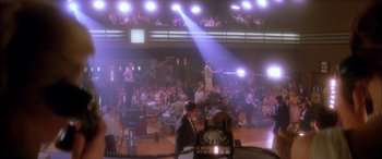 Movie still from “Where the Truth Lies” (2005), directed by Atom Egoyan – A crowd of people in a room with lights on; Extreme Wide shot, High angle