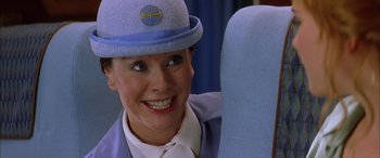 Movie still from “Where the Truth Lies” (2005), directed by Atom Egoyan – A woman wearing a hat and smiling for the camera; Close Up shot, Over the shoulder angle