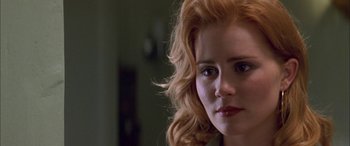 Movie still from “Where the Truth Lies” (2005), directed by Atom Egoyan – A woman with red hair looking at the camera; Close Up shot, Over the shoulder angle