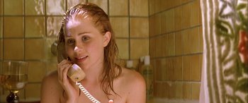Movie still from “Where the Truth Lies” (2005), directed by Atom Egoyan – A woman in a bathroom talking on a phone; Close Up shot, Low angle