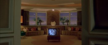 Movie still from “Where the Truth Lies” (2005), directed by Atom Egoyan – An old tv sitting in the middle of a living room; Extreme Wide shot, High angle