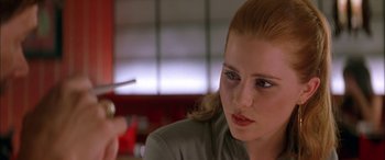 Movie still from “Where the Truth Lies” (2005), directed by Atom Egoyan – A person with a pen in their hand; Close Up shot, Over the shoulder angle