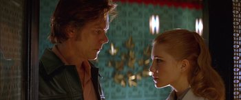 Movie still from “Where the Truth Lies” (2005), directed by Atom Egoyan – A man and a woman face to face in front of a wall; Close Up shot, Low angle