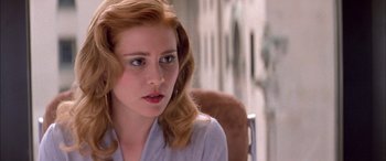 Movie still from “Where the Truth Lies” (2005), directed by Atom Egoyan – A person sitting in a chair; Close Up shot, Over the shoulder angle