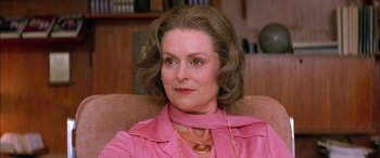 Movie still from “Where the Truth Lies” (2005), directed by Atom Egoyan – An older woman wearing a pink shirt and a gold necklace; Close Up shot, Low angle