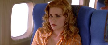 Movie still from “Where the Truth Lies” (2005), directed by Atom Egoyan – A woman sitting in a chair on top of an airplane; Close Up shot, High angle