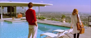 Movie still from “Where the Truth Lies” (2005), directed by Atom Egoyan – A man standing in front of a pool looking out over the city; Extreme Wide shot, Low angle