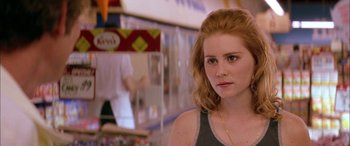 Movie still from “Where the Truth Lies” (2005), directed by Atom Egoyan – A person wearing a tank top; Close Up shot, Over the shoulder angle