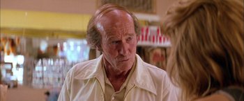 Movie still from “Where the Truth Lies” (2005), directed by Atom Egoyan – An older man with a beard and a white shirt; Close Up shot, Over the shoulder angle