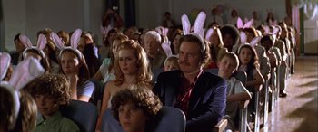 Movie still from “Where the Truth Lies” (2005), directed by Atom Egoyan – A group of people sitting in a room with bunny ears on their heads; Medium shot, High angle