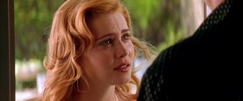 Movie still from “Where the Truth Lies” (2005), directed by Atom Egoyan – A person with long red hair; Close Up shot, Over the shoulder angle