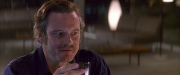 Movie still from “Where the Truth Lies” (2005), directed by Atom Egoyan – A person holding a glass of wine; Close Up shot, Over the shoulder angle