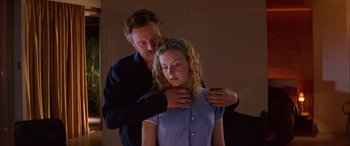 Movie still from “Where the Truth Lies” (2005), directed by Atom Egoyan – A man and a woman are holding their hands over their shoulders; Medium shot, Low angle