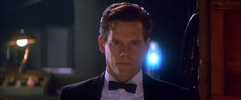 Movie still from “Where the Truth Lies” (2005), directed by Atom Egoyan – A person wearing a suit and bow tie; Close Up shot, Low angle