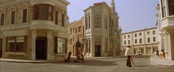 Movie still from “Where the Truth Lies” (2005), directed by Atom Egoyan – An empty street with a clock tower in the background; Extreme Wide shot, High angle
