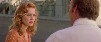 Movie still from “Where the Truth Lies” (2005), directed by Atom Egoyan – A woman talking to a man on the side of the street; Close Up shot, Over the shoulder angle