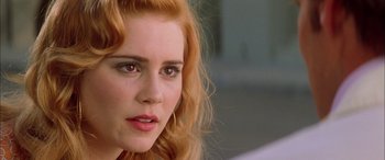 Movie still from “Where the Truth Lies” (2005), directed by Atom Egoyan – A woman with red hair; Close Up shot, Over the shoulder angle