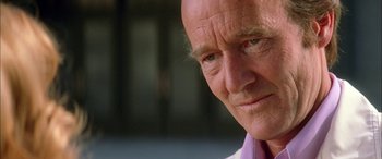 Movie still from “Where the Truth Lies” (2005), directed by Atom Egoyan – An old man with a bald head looking at the camera; Close Up shot, Over the shoulder angle
