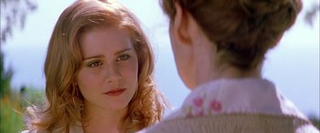 Movie still from “Where the Truth Lies” (2005), directed by Atom Egoyan – A woman looking into a mirror while standing next to another woman; Close Up shot, Over the shoulder angle