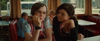 Movie still from “Whip It” (2009), directed by Drew Barrymore – Two young women sitting next to each other on a table; Close Up shot, Over the shoulder angle