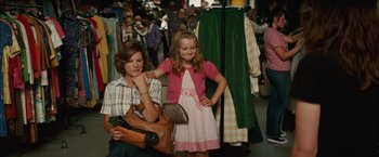 Movie still from “Whip It” (2009), directed by Drew Barrymore – A woman and a little girl in a dress shop; Medium shot, Over the shoulder angle