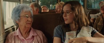 Movie still from “Whip It” (2009), directed by Drew Barrymore – A group of people sitting on a bus; Close Up shot, Over the shoulder angle