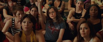 Movie still from “Whip It” (2009), directed by Drew Barrymore – A group of people sitting in a room; Medium shot, High angle