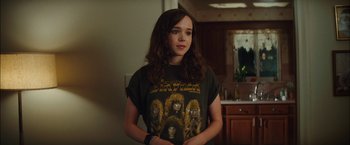 Movie still from “Whip It” (2009), directed by Drew Barrymore – A woman in a black shirt holding her hands in front of her face; Medium shot, Over the shoulder angle